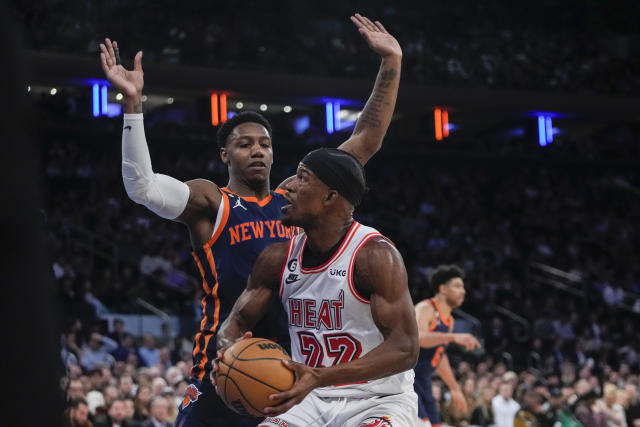 New York Knicks' RJ Barrett, left, defends Miami Heat's Jimmy Butler during the first half of an NBA basketball game, Thursday, Feb. 2, 2023, in New York. (AP Photo/Frank Franklin II)