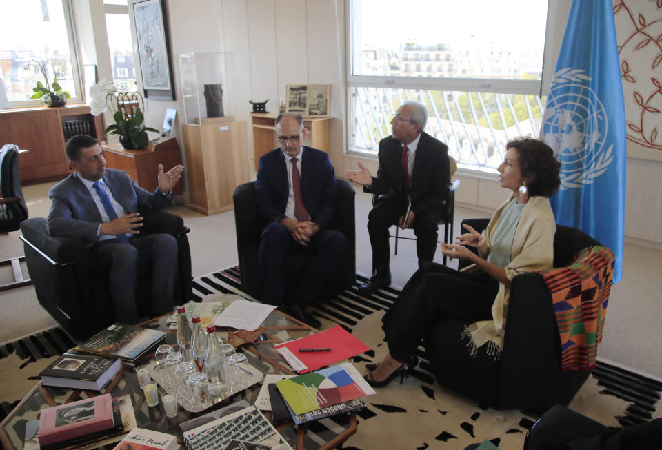 Governor of the province Nineveh Mansour al-Mareed, left, and Iraq's Culture Minister Abdulamir al-Dafar Hamdani, center, meet UNESCO'S Director-General Audrey Azoulay at the UNESCO's headquarters in Paris, Wednesday, Sept. 11. 2019. Iraqi officials meet at the UN's cultural agency in Paris to discuss plans for an ambitious $100 million reconstruction of the Islamic State-ravaged city of Mosul. (AP Photo/Michel Euler)