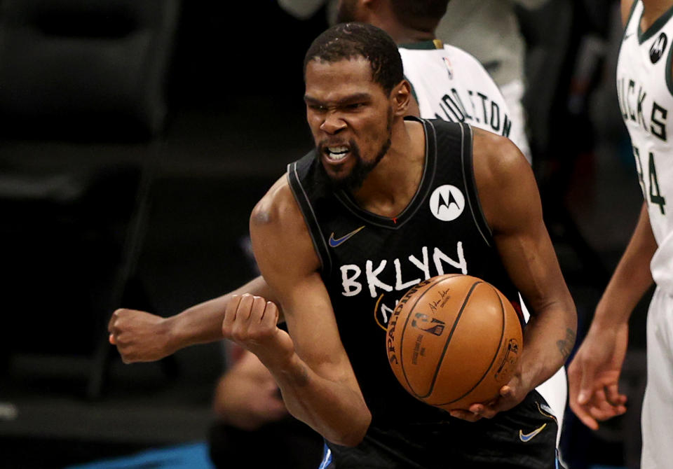 Kevin Durant pumps his fist as he celebrates after being fouled.