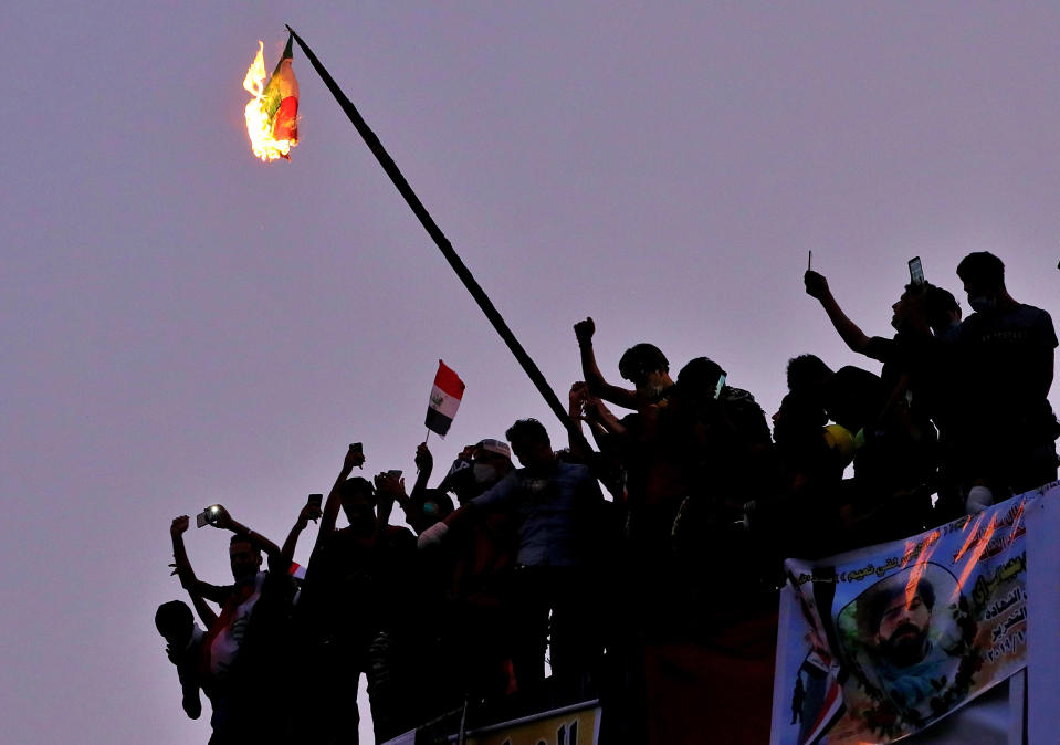 Iraqi anti-government protesters burn the Iranian flag during a demonstration in Baghdad, Iraq, Tuesday, Oct. 29, 2019. (AP Photo/Hadi Mizban)