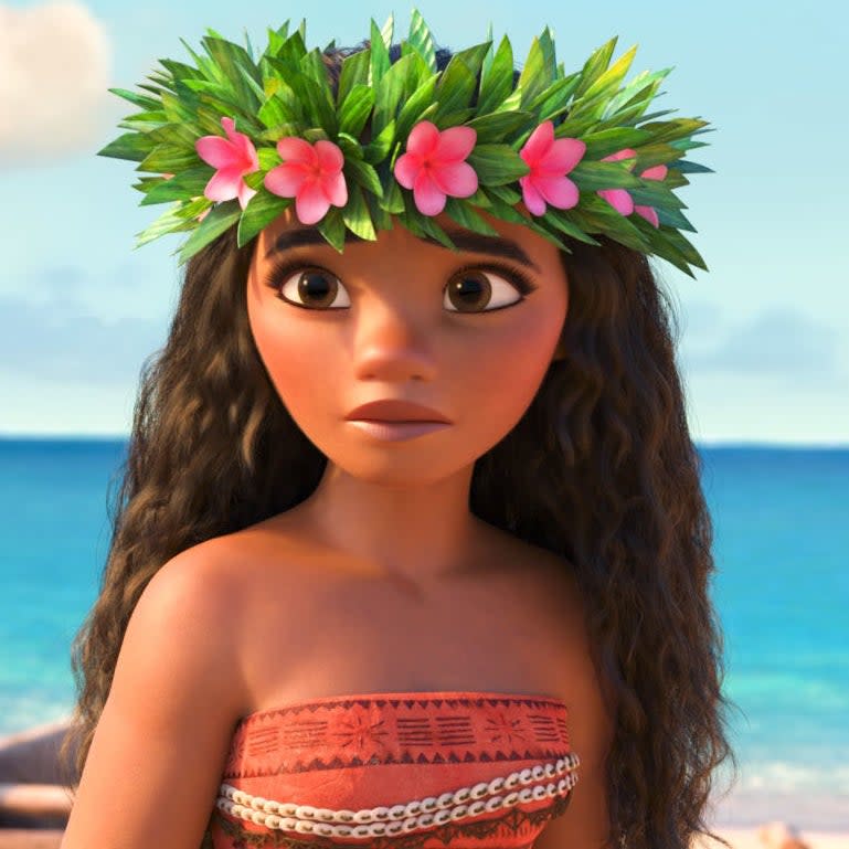 Animated character Moana wearing a floral headpiece looks onward with determination