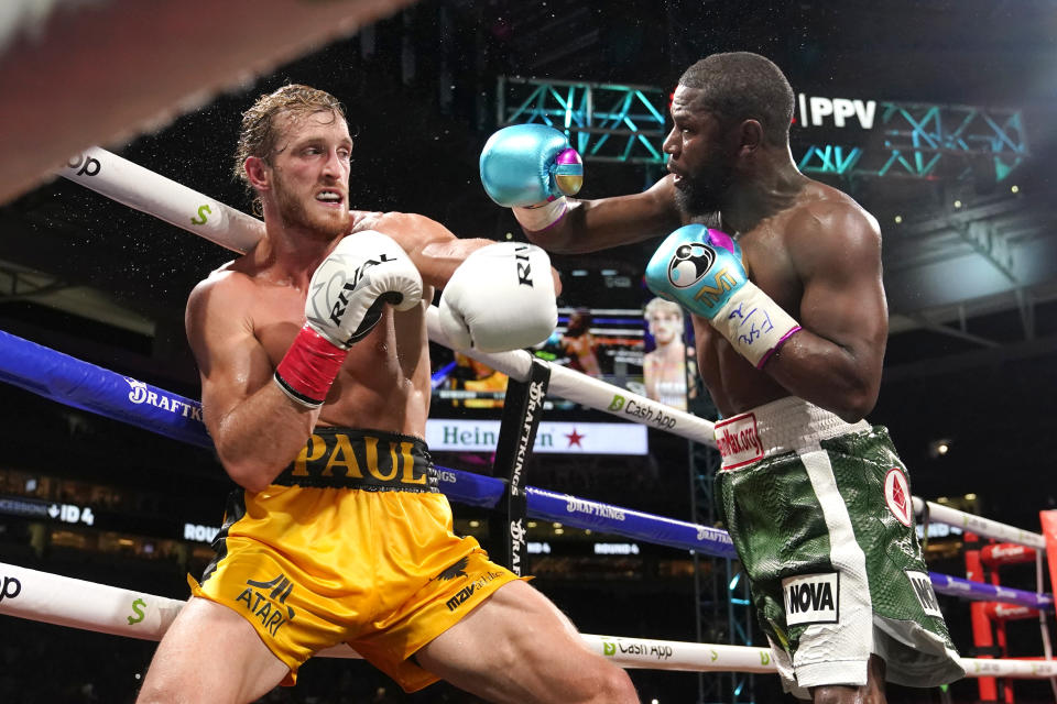 FILE - Logan Paul, left, and Floyd Mayweather, right, fight during an exhibition boxing match at Hard Rock Stadium, Sunday, June 6, 2021, in Miami Gardens, Fla. Logan Paul has 25 1/2 million Instagram followers and a spot in WWE's main event on Saturday's card in Saudi Arabia. (AP Photo/Lynne Sladky, File)
