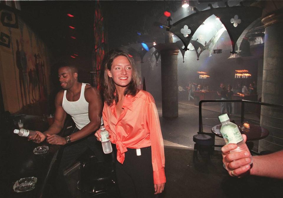 Dwayne Snow of Miami and tourist Brenda Pranigan drink bottled water at the Warsaw Ballroom on Sept. 30, 1996.