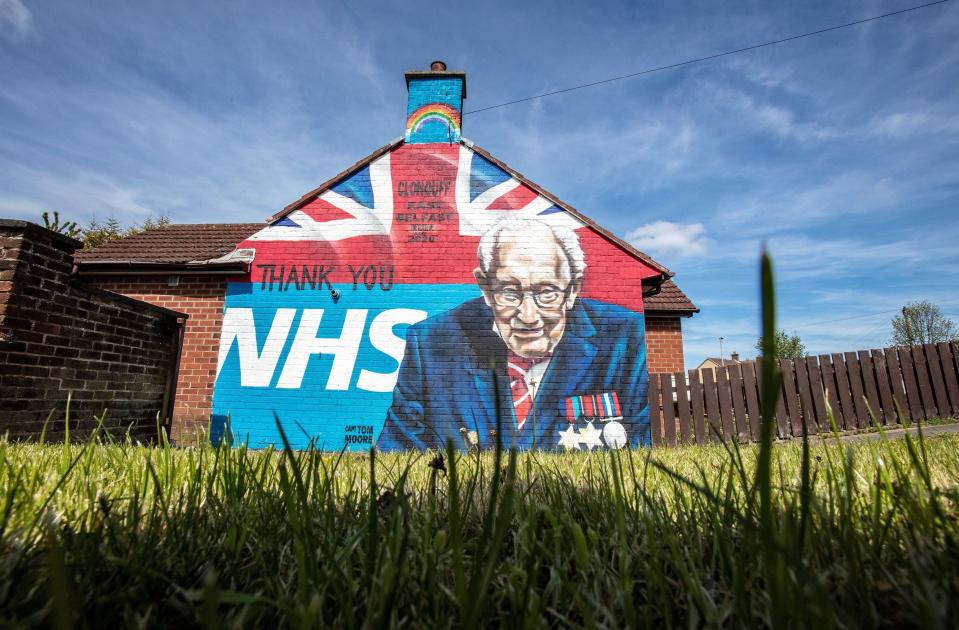 TOPSHOT - A street art graffiti mural, showing the logo of the NHS (National Health Service), and an image 100-year-old veteran Captain Tom Moore who raised over GBP 30 million for NHS charities, is pictured in east Belfast on May 5, 2020. - The number of people killed by the coronavirus in the UK stands at 32,313, according to official figures on May 5 2020, the second highest death toll in the world. Figures from the Office for National Statistics showed Britain had now overtaken Italy, which has reported 29,029 fatalities, and now only stands behind the US with 68,700 deaths, the largest single-country toll. (Photo by Paul Faith / AFP) (Photo by PAUL FAITH/AFP via Getty Images)