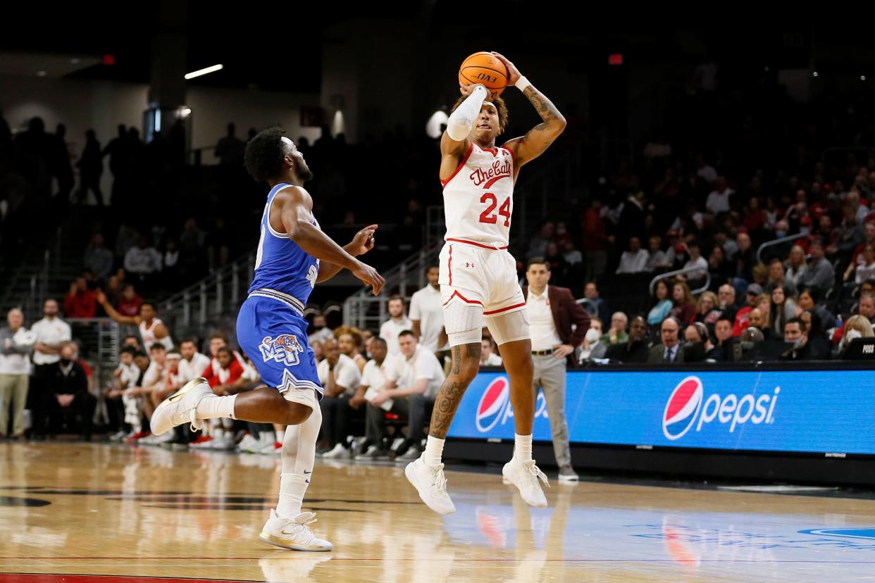 Cincinnati Bearcats guard Jeremiah Davenport (24) shoots from three point range in the first half of the NCAA American Athletic Conference basketball game between the Cincinnati Bearcats and the Memphis Tigers at Fifth Third Arena in Cincinnati on Tuesday, Feb. 15, 2022. 