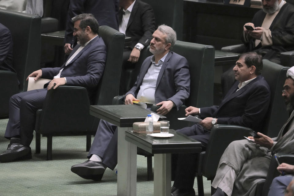 Iranian Industries Minister Reza Fatemi Amin, center, listens during an open session of parliament for his impeachment, in Tehran, Iran, Sunday, April 30, 2023. Iran's parliament voted Sunday to fire Fatemi Amin over alleged mismanagement amid widespread dissatisfaction with the government. (AP Photo/Vahid Salemi)