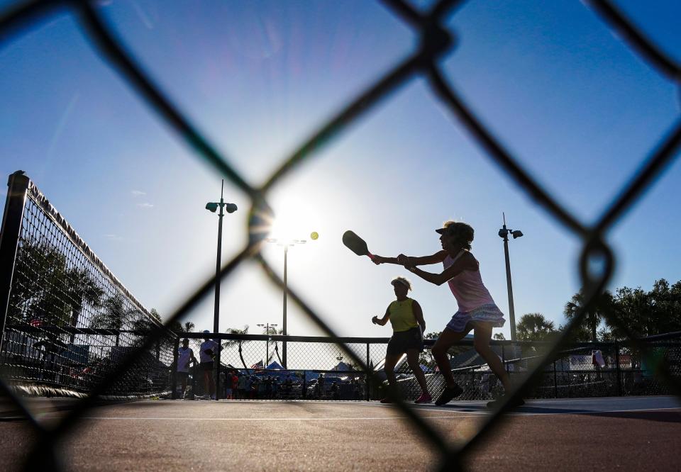 A pickleball player returns a serve during the seventh annual Minto U.S. Open Pickleball Championships at East Naples Community Park in Naples on Monday, April 17, 2023.