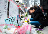 <p>A women fights back tears at a memorial along Yonge Street, Tuesday, April 24, 2018, in Toronto, the day after a driver drove a van down sidewalks, striking and killing numerous pedestrians in his path. (Photo: Nathan Denette/The Canadian Press via AP) </p>