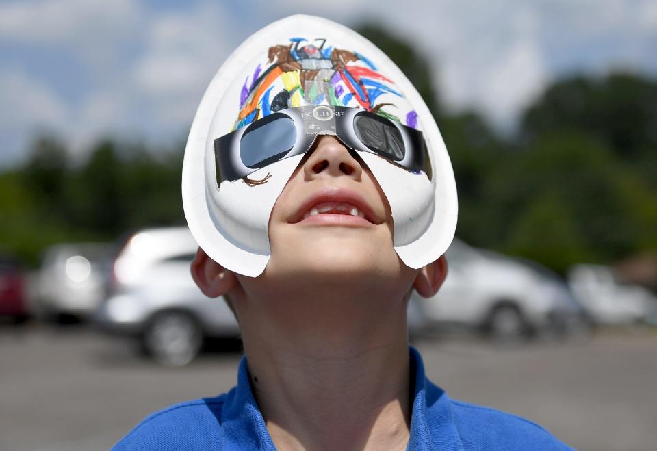 Community Montessori School student Jack Priddy looks up at the sky at the start of the solar eclipse on Monday, Aug. 21, 2017 in Jackson, Tenn.
