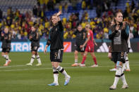Germany's Marina Hegering, center, and Sydney Lohmann, right, applaud the fans at the end of the Women's World Cup Group H soccer match between Germany and Colombia at the Sydney Football Stadium in Sydney, Australia, Sunday, July 30, 2023. Colombia won 2-1. (AP Photo/Mark Baker)