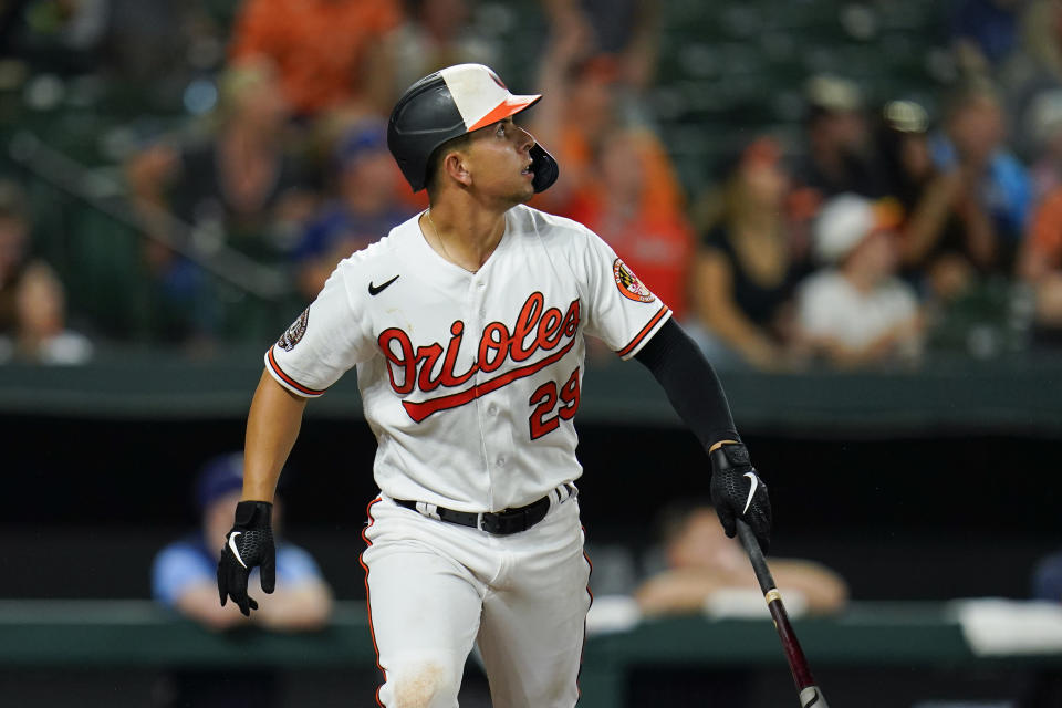 Baltimore Orioles' Ramon Urias watches his ball while hitting a two-run home run against Tampa Bay Rays relief pitcher Colin Poche during the eighth inning of a baseball game, Tuesday, July 26, 2022, in Baltimore. Orioles' Adley Rutschman scored on the home run. The Orioles won 5-3. (AP Photo/Julio Cortez)