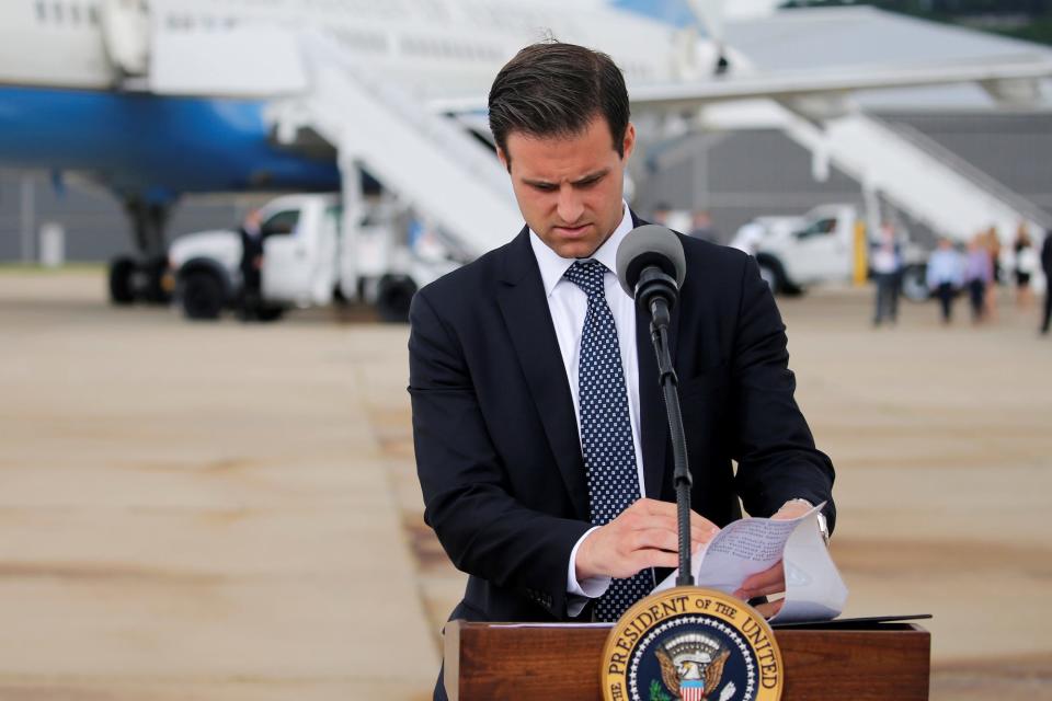 Personal aide John McEntee lays presets papers on a lectern for U.S. President Donald Trump to delivers remarks in Cincinnati, Ohio, U.S. June 7, 2017.