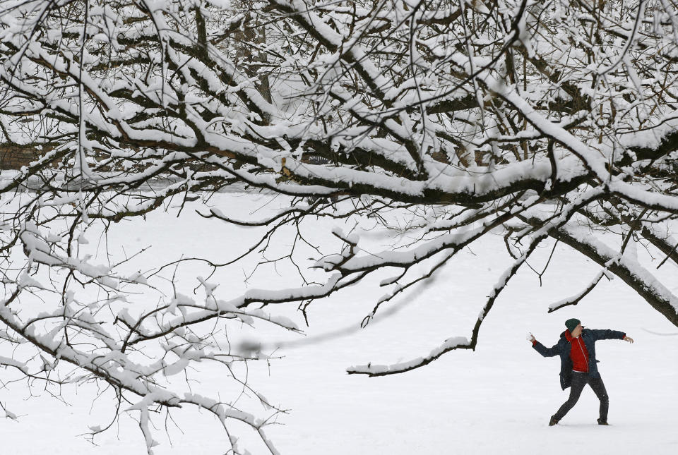 <p>A man throws a snowball in a park Wednesday, March 21, 2018, in Baltimore. A spring nor’easter targeted the Northeast on Wednesday with strong winds and a foot or more of snow expected in some parts of the region. (Photo: Patrick Semansky/AP) </p>