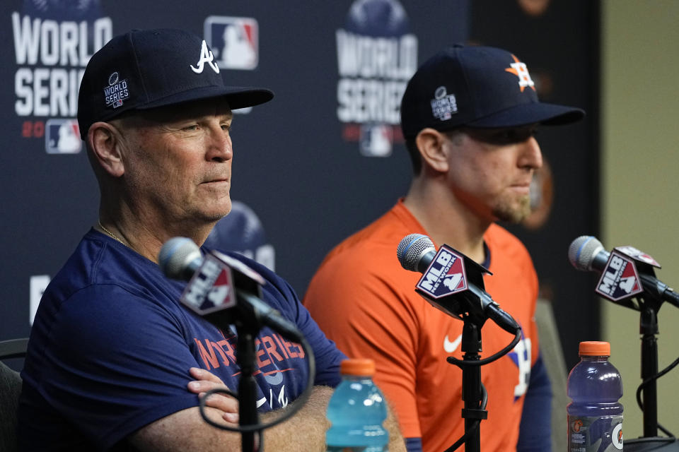 Atlanta Braves manager Brian Snitker and Houston Astros hitting coach Troy Snitker speak during a news conference before Game 1 of baseball's World Series Tuesday, Oct. 26, 2021, in Houston. (AP Photo/Ashley Landis)