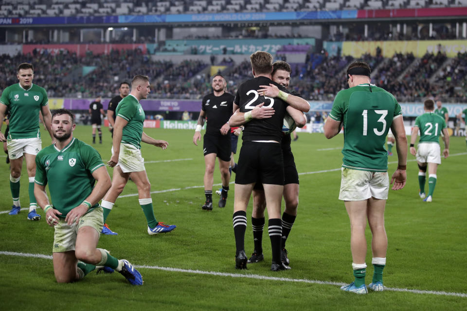 New Zealand's Jordie Barrett (25) celebrates with teammates after scoring a try against Ireland's Robbie Henshaw during the Rugby World Cup quarterfinal match at Tokyo Stadium between New Zealand and Ireland in Tokyo, Japan, Saturday, Oct. 19, 2019. (AP Photo/Jae C. Hong)