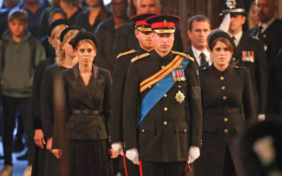 Princesses Beatrice and Eugenie walk behind Prince William as they process towards the Queen’s coffin (POOL/AFP via Getty Images)