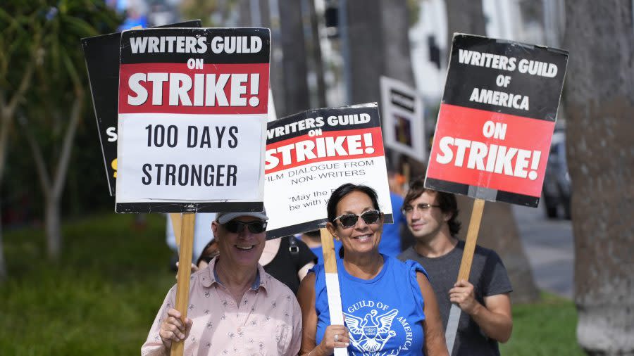 Picketers demonstrate outside Netflix studios on Wednesday, Aug. 9, 2023, in Los Angeles. The Hollywood writers strike reached the 100-day mark today as the U.S. film and television industries remain paralyzed by dual actors and screenwriters strikes. (AP Photo/Chris Pizzello)