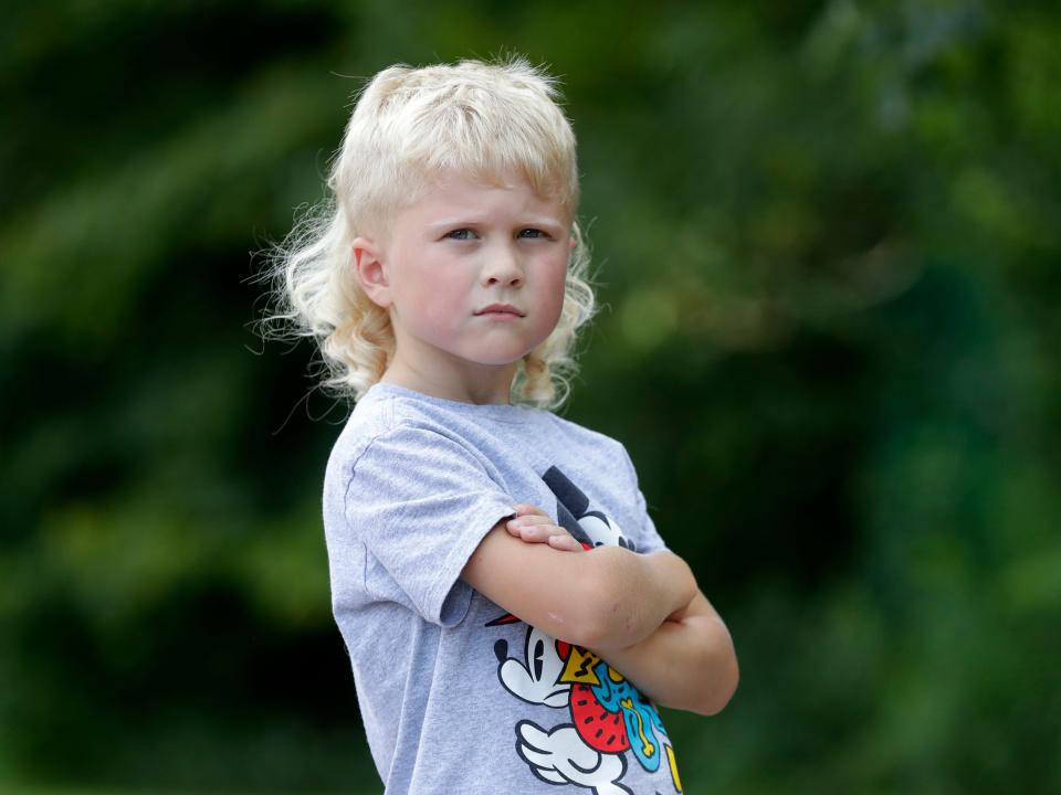 Axel Wenzel, 5, of Brillion is pictured outside Hemlock Creek Elementary School in the Town of Lawrence. Wenzel is a finalist in the 2022 USA Mullet Championships.