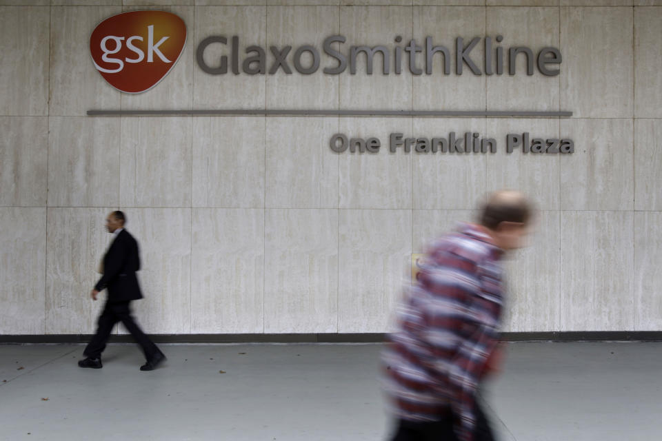 File- In this Nov. 5, 2008 file photo passers-by walk past the American headquarters of British drug maker GlaxoSmithKline PLC, in Philadelphia. A federal judge in Boston approved Thursday, July 5, 2012 to an agreement by British drugmaker GlaxoSmithKline to pay $3 billion for criminal and civil violations involving 10 drugs, marking the largest health care fraud settlement in U.S. history. (AP Photo/Matt Rourke, File)