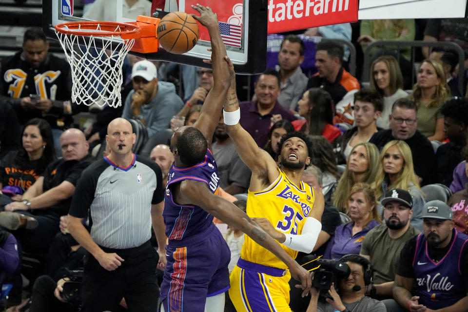 Phoenix Suns forward Kevin Durant shoots as Los Angeles Lakers forward Christian Wood, right, defends during the during the second half of an NBA basketball in-season tournament game, Friday, Nov. 10, 2023, in Phoenix. (AP Photo/Matt York)