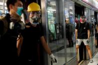 Protest at Yuen Long MTR station, the scene of an attack by suspected triad gang members a month ago, in Hong Kong