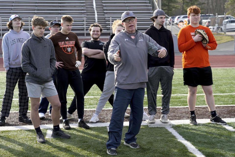 East Palestine High School baseball coach Bill Sattler instructs his team during practice, Monday, March 6, 2023, in East Palestine, Ohio. Athletes are navigating spring sports following the Feb. 3 Norfolk Southern freight train derailment. (AP Photo/Matt Freed)