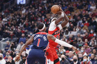 Toronto Raptors forward Pascal Siakam (43) shoots over Washington Wizards guard Kentavious Caldwell-Pope (1) during first-half NBA basketball game action in Toronto, Sunday, Dec. 5, 2021. (Cole Burston/The Canadian Press via AP)