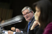 European Commissioner for Security Union Julian King, center, speaks during a media conference for the Presidency press release on member states' report on EU coordinated risk assessment of 5G network security at the European Council building in Brussels, Wednesday, Oct. 9, 2019. (AP Photo/Virginia Mayo)