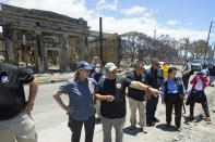 FILE - Hawaii Gov. Josh Green, center, points to damage as he speaks with Federal Emergency Management Agency Administrator Deanne Criswell during a tour of wildfire damage, Saturday, Aug. 12, 2023, in Lahaina, Hawaii. In an interview, Gov. Josh Green told The Associated Press the state is building transitional and long-term housing, changing laws to convert 7,000 vacation rentals to long-term rentals, and swiftly settling lawsuits by fire survivors, so plaintiffs can get the money they need to start rebuilding. (AP Photo/Rick Bowmer, File)