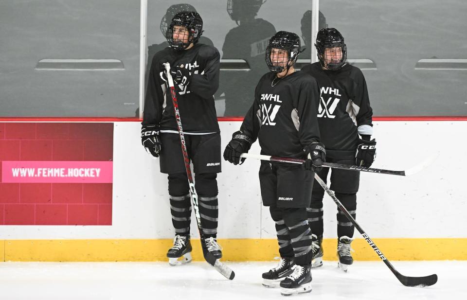 Montreal's Marie-Philip Poulin, centre, talks with teammates during the Professional Women's Hockey League’s (PWHL) training camp in Montreal, Saturday, November 18, 2023. THE CANADIAN PRESS/Graham Hughes