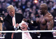 <p>Trump and Bobby Lashley shave the head of Vince McMahon after Lashley defeated Umaga at WrestleMania 23 at Ford Field in Detroit in 2007. <i>(Photo: Carlos Osorio/AP)</i> </p>