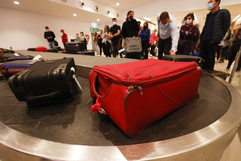 Airport arrivals collect luggage at Hobart Airport in Hobart.