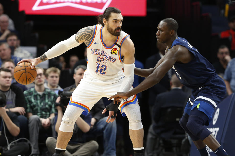 Oklahoma City Thunder's Steven Adams, left, of New Zealand keeps the ball at arms length form Minnesota Timberwolves' Gorgui Dieng, of Senegal, in the first half of an NBA basketball game Monday, Jan. 13, 2020, in Minneapolis. (AP Photo/Jim Mone)
