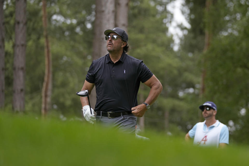 Phil Mickelson of the United States watches the flight of his ball after playing off the 4th tee during the first round of the inaugural LIV Golf Invitational at the Centurion Club in St. Albans, England, Thursday, June 9, 2022. (AP Photo/Alastair Grant)