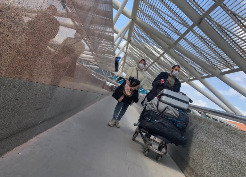 Passengers wear protective face masks upon their arrival, at Cairo International Airport (CAI) as Egypt ramps up its efforts to slow the spread the coronavirus disease (COVID-19) in Cairo