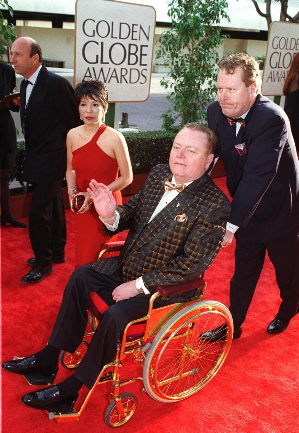 FILE - "Hustler" magazine publisher Larry Flynt arrives in a wheelchair for the 54th annual Golden Globe Awards on Jan. 19, 1997, in Beverly Hills, Calif. Flynt, who turned "Hustler" magazine into an adult entertainment empire while championing First Amendment rights, has died at age 78. His nephew, Jimmy Flynt Jr., told The Associated Press that Flynt died Wednesday, Feb. 10, 2021, of heart failure at his Hollywood Hills home in Los Angeles. (AP Photo/Chris Pizzello, File)