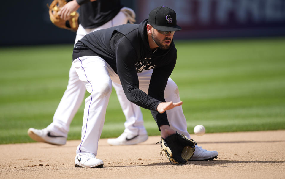 Colorado Rockies first baseman Mike Moustakas warms up for the team's baseball game against the Los Angeles Angels on Friday, June 23, 2023, in Denver. (AP Photo/David Zalubowski)