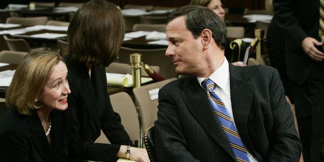 John Roberts turns to look at Jane Roberts while both are sitting.