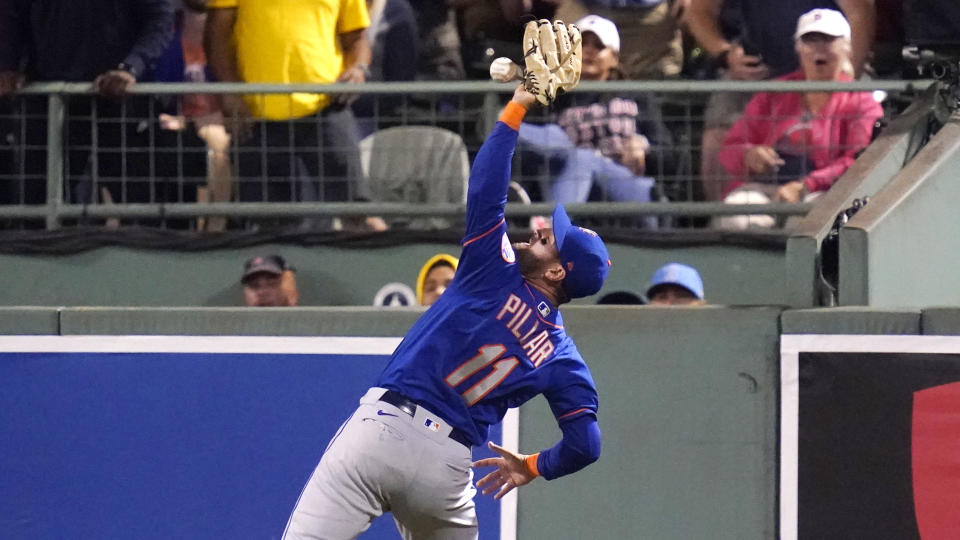 New York Mets right fielder Kevin Pillar (11) reaches up but fails to glove the ball on a triple by Boston Red Sox's Jose Iglesias during the third inning of a baseball game at Fenway Park, Wednesday, Sept. 22, 2021, in Boston. (AP Photo/Charles Krupa)