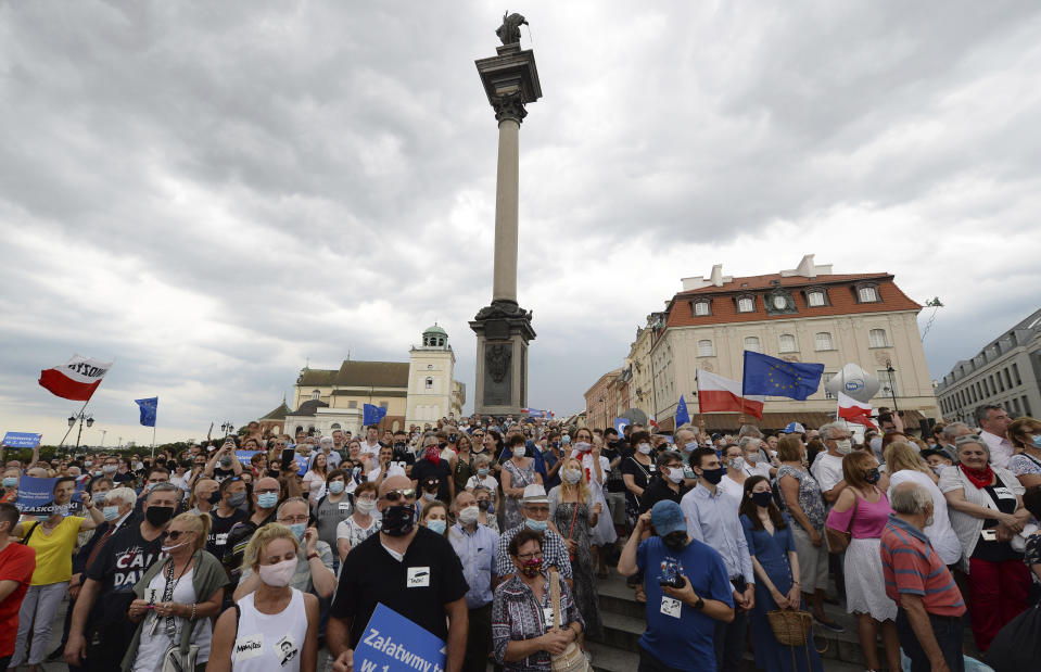 Supporters attend a rally of a candidate in Poland's presidential election, Warsaw centrist Mayor Rafal Trzaskowski on the last day of campaigning before Sunday's vote, in Castle Square in Warsaw, Poland, on Friday, June 26, 2020. Trzaskowski is a major challenger to incumbent conservative President Andrzej Duda who is seeking a second five-year term and is leading in the polls. (AP Photo/Czarek Sokolowski)