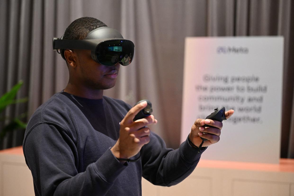 A Meta employee demonstrates the Meta Quest Pro VR Headset in Las Vegas, Nevada, on January 4, 2023. - The Met Quest Pro VR headset features VR improvements including high-res sensors that enable full-color mixed reality experiences, next-gen pancake optics, and advanced LCD displays. (Photo by Robyn BECK / AFP) (Photo by ROBYN BECK/AFP via Getty Images)