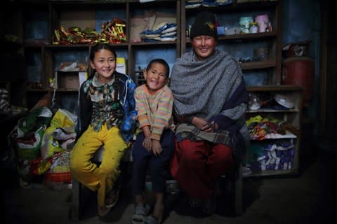 Laxmi Lama, 35, with her son and daughter at her food store in Solambu village, Chauri Deurali Rural Municipality, Kavrepalanchok District, Nepal - Credit: Bikram Rai&nbsp;