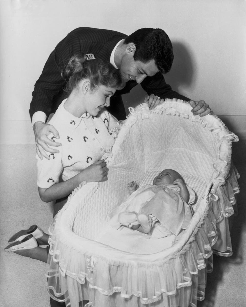 Carrie Frances Fisher was born on Oct. 21, 1956. Her father, Eddie Fisher, and mother, Debbie Reynolds, watch over her.
