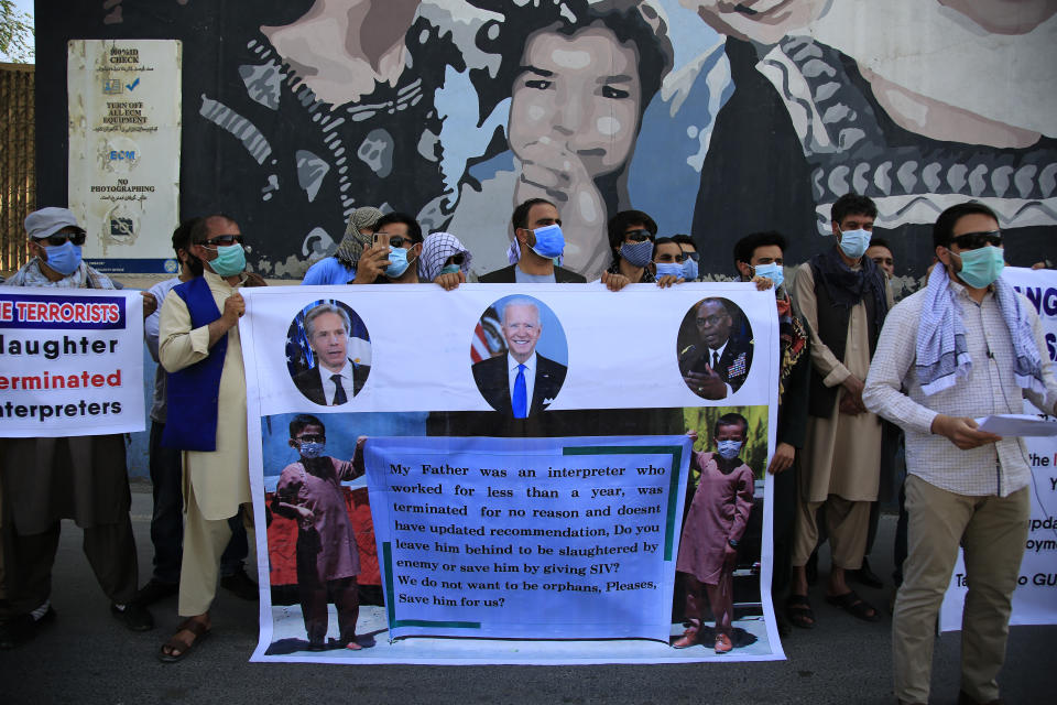 FILE - In this June 25, 2021, file photo, former Afghan interpreters hold placards during a demonstrations against the US government, in front of the US Embassy in Kabul, Afghanistan. The House voted overwhelmingly Thursday, July 22, to allow in thousands more of the Afghans who worked alongside Americans in the Afghanistan war, citing the urgency of protecting those on-the-ground allies from Taliban retaliation as the U.S. military withdrawal enters its final weeks. (AP Photo/Mariam Zuhaib, File)