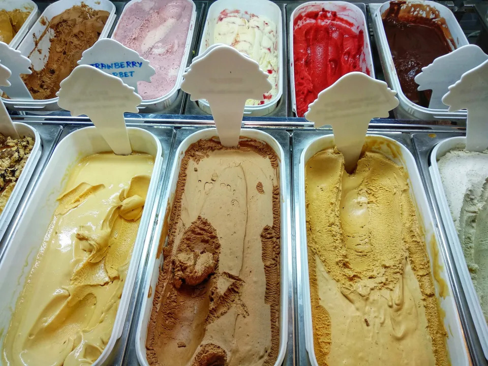 An ice cream display with many flavors