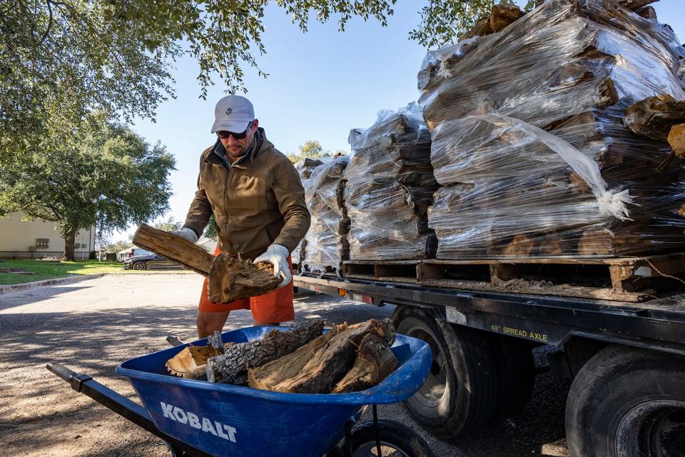 Matt Warner of Warner Firewood delivers wood to a customer in East Austin on Friday. Warner said his business has seen an influx of delivery requests in preparation for freezing weather.