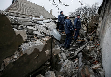 Emergencies Ministry members inspect a building which was damaged during fighting between the Ukrainian army and pro-Russian separatists in the government-held industrial town of Avdiyivka, Ukraine, February 6, 2017. REUTERS/Gleb Garanich