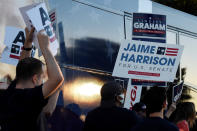 Supporters wave signs and chant outside the final debate between U.S. Sen. Lindsey Graham of South Carolina and Democratic challenger Jaime Harrison on Friday, Oct. 30, 2020, in Columbia, S.C. (AP Photo/Meg Kinnard)