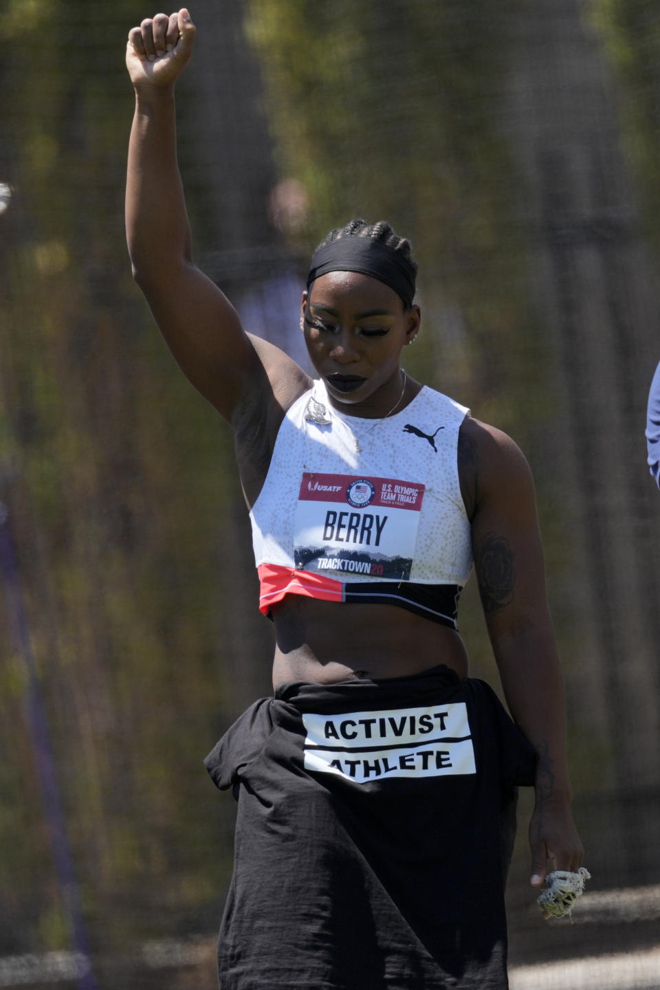 Gwendolyn Berry lifts her arm during introductions for the prelims of the women's hammer throw at the U.S. Olympic Track and Field Trials Thursday, June 24, 2021, in Eugene, Ore. (AP Photo/Ashley Landis)