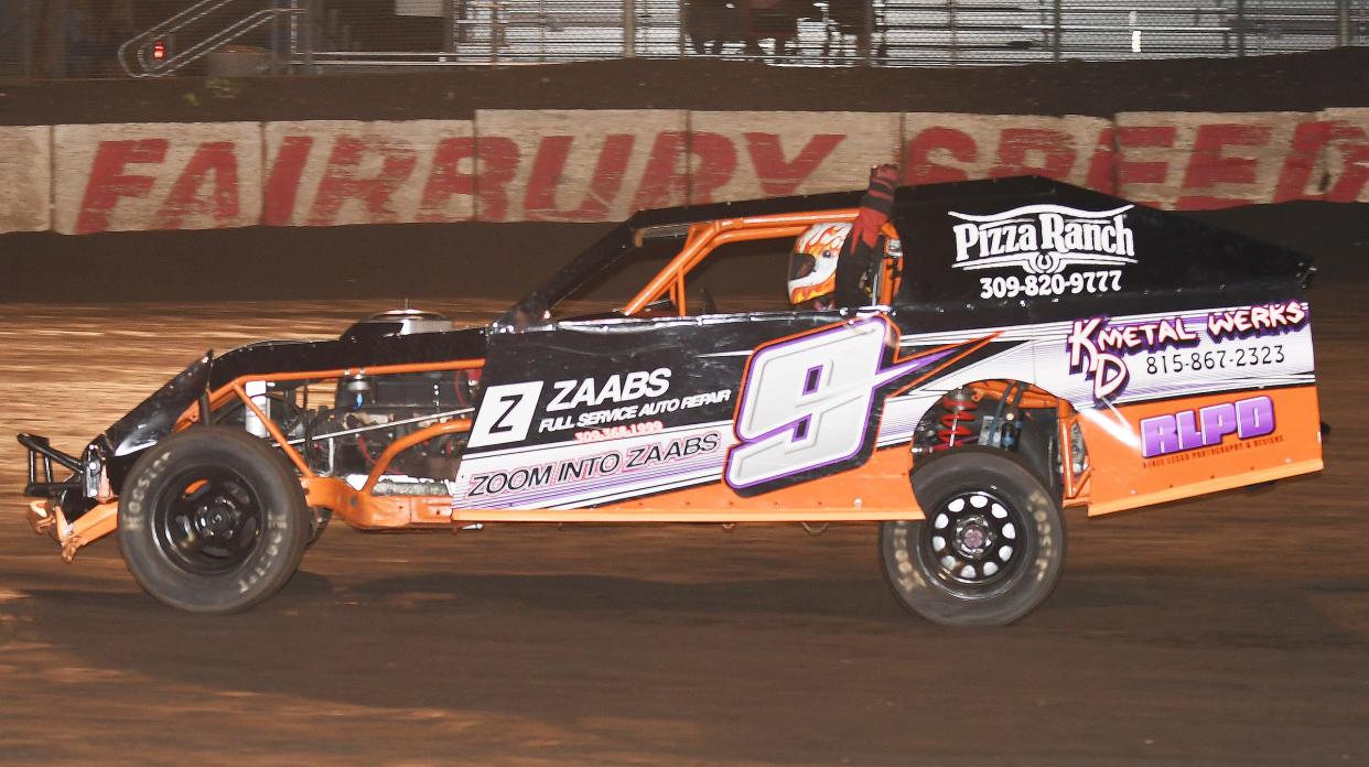 Brian Deavers pumps his fist in celebrating his win in the hobby-modified race Saturday night at Fairbury Speedway.